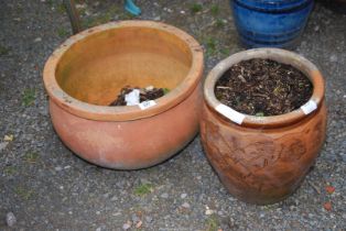 Two terracotta planters, one being glazed.