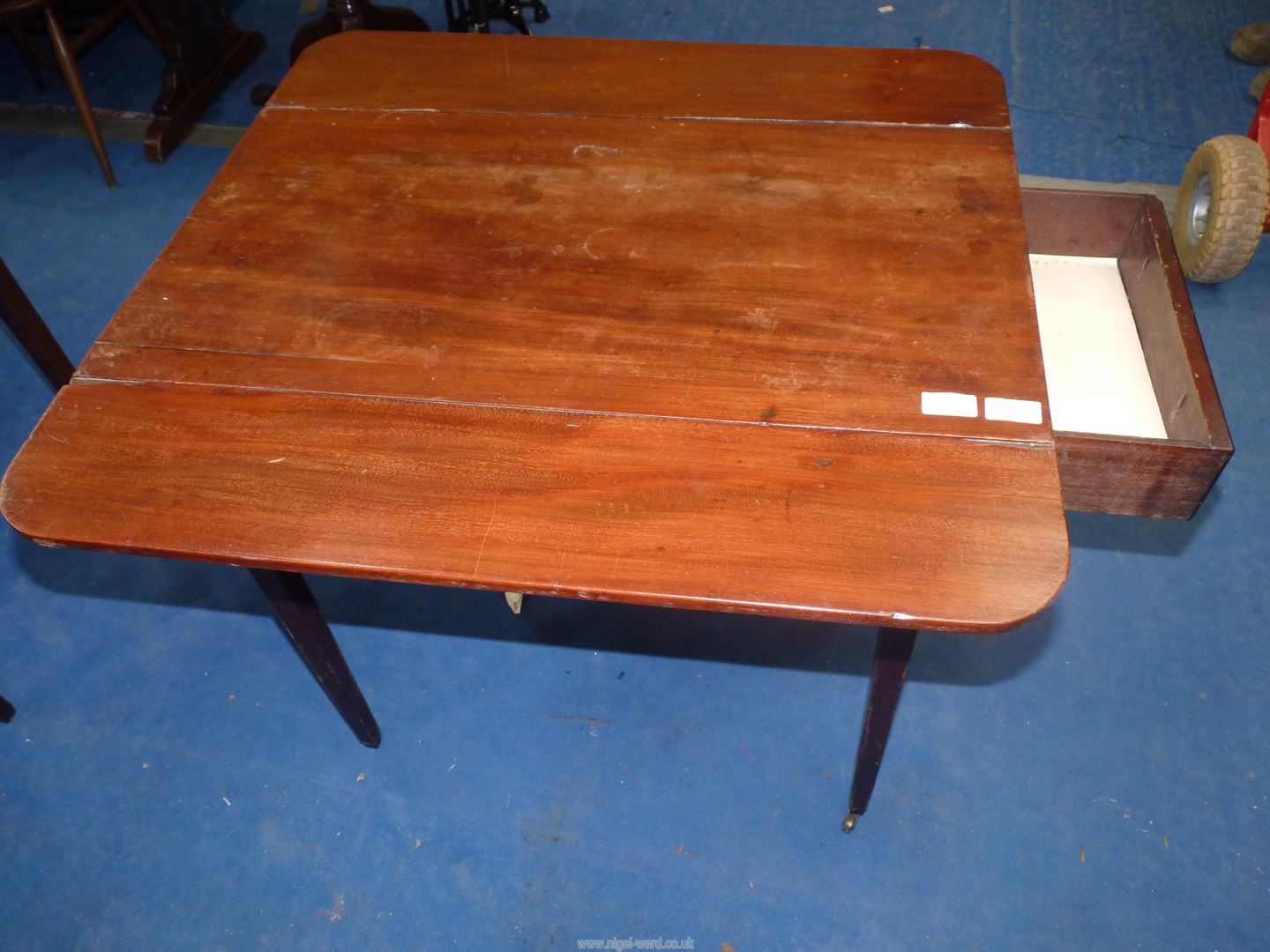 A Mahogany Pembroke table, standing on tapering square legs with brass castors, with drawer, - Image 2 of 3
