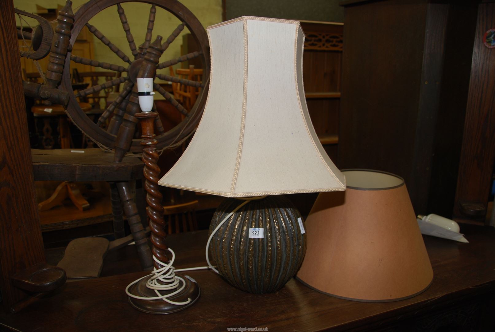 A spiral wooden table lamp and a ridged bulbous body table lamp and five shades.