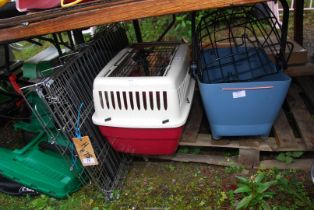 A metal dog crate plus two pet carriers.