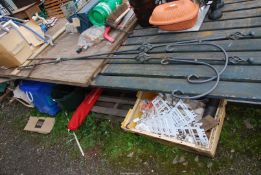 Two wrought iron hangers for hanging baskets.