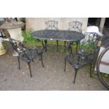 A black painted Aluminium decorative patio Table, 55" wide x 28" high and four chairs.