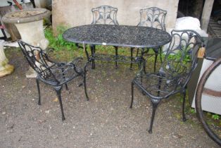 A black painted Aluminium decorative patio Table, 55" wide x 28" high and four chairs.