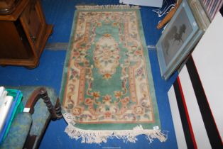 A Chinese green pattern rug, 30" x 61".