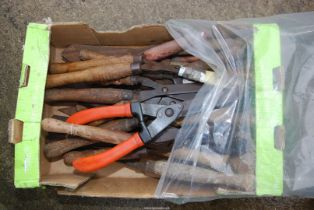 A box of a large quantity of grass shears.