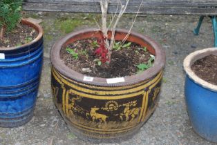 A glazed planter with reindeer figures.