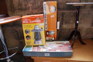 A portable bug zapper plus a 18 piece wooden handle barbecue set and ten night lights.