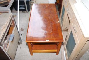 A coffee table with lower shelf.