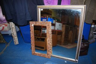 Two mirrors, one being a carved wood frame.