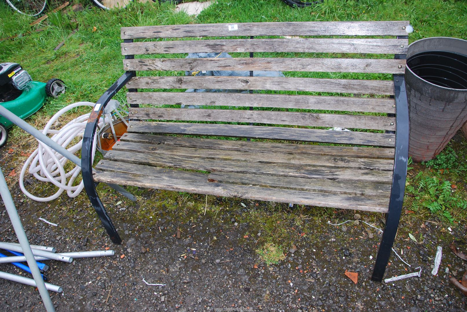 A garden bench, 4' wide x 31" high (one broken slat).