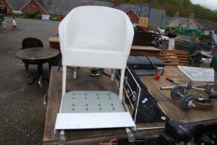 A corner plant stand and a disability bath set and a Lloyd Loom style chair.