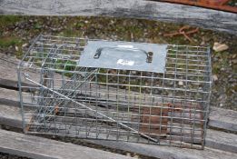 A galvanized rabbit trap.