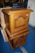 A mirrored pair of Oak bedside cabinets on turned feet.