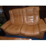 A Ekornes Stressless type tan soft hide upholstered Lounge Suite comprising a two seater settee and