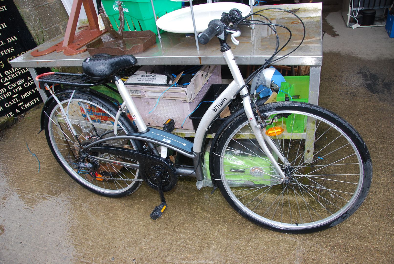 A B-twin 18 speed ladies push Bicycle with carrier rack.