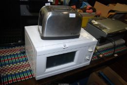 A small Microwave and electric toaster.