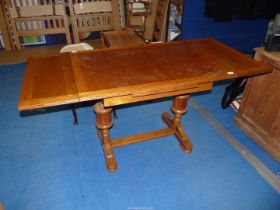 An Oak extending table, 64" x 29 1/2" x 30" high, open.