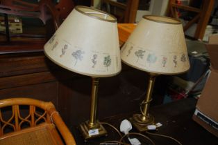 A pair of brass table lamps and shades.