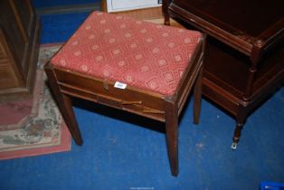 An Oak framed piano stool.