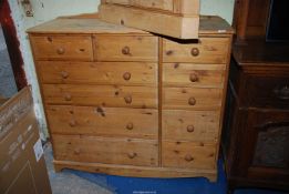 A large Pine chest of of four long and two short drawers flanked by five short drawers,