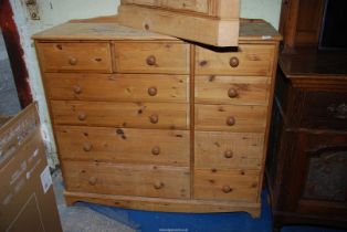 A large Pine chest of of four long and two short drawers flanked by five short drawers,