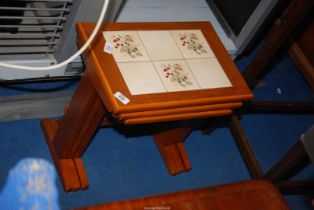 Tiled top nest of three tables.