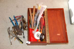 A wooden box containing various tools, pipe pliers, copper pipe molegrips, etc.