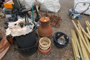 A chiminea, glazed pots, dustbin containing flat pack greenhouse.