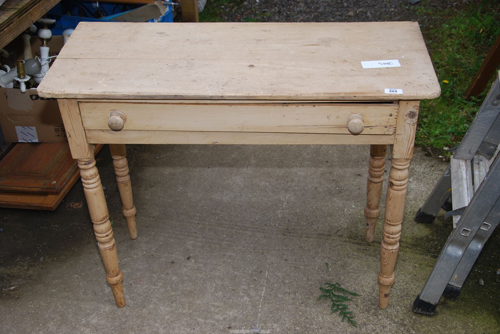 A pine hall table with drawer.