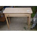 A pine hall table with drawer.