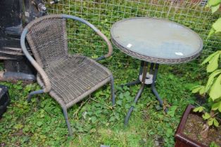 A circular glass topped table, 2' diameter x 28" high and a single chair.