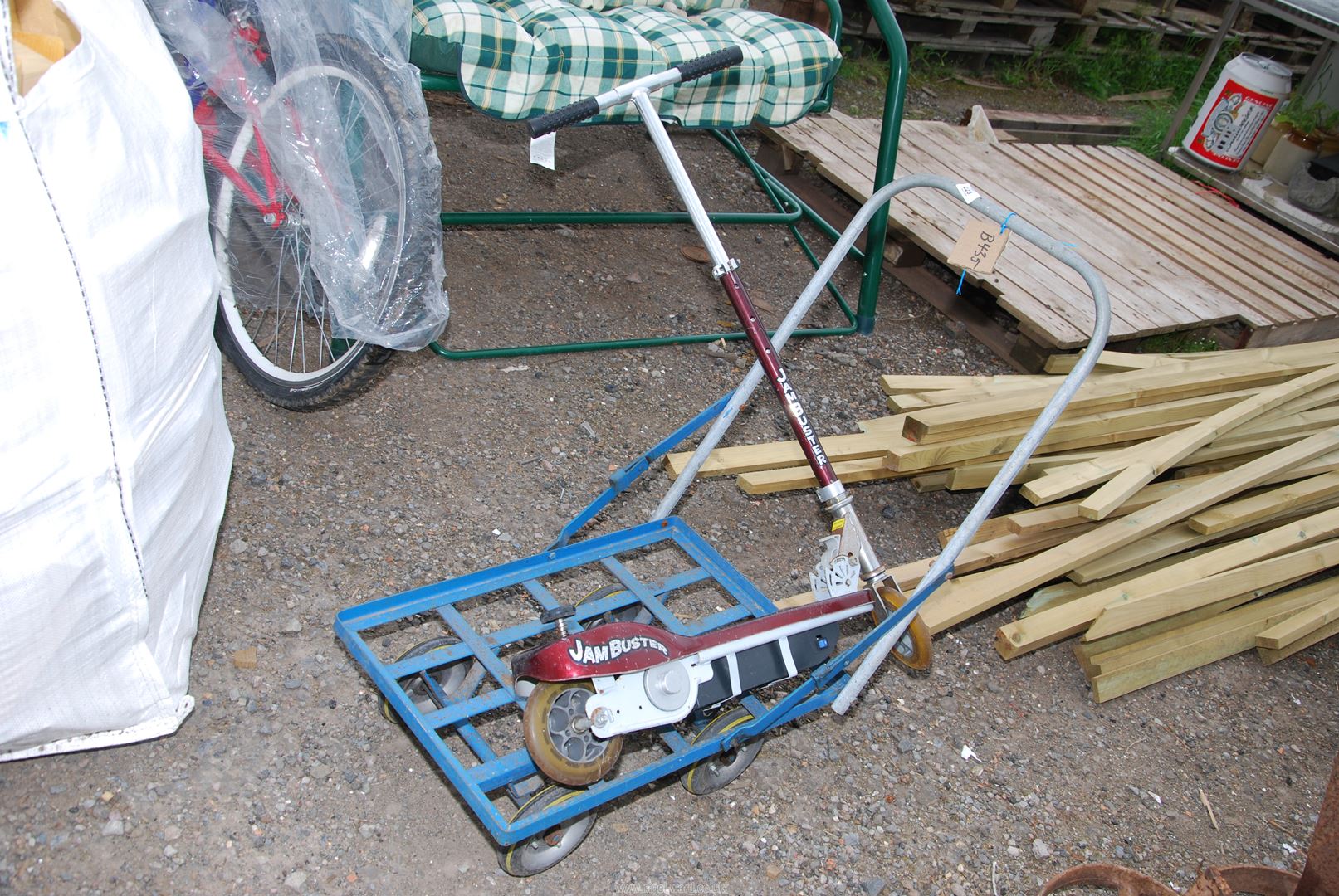 A four wheel hand trolley and electric 'jam buster' scooter.