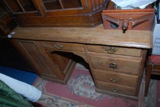 A pine writing pedestal desk, each with four drawers, frieze drawer, brass drop handles,