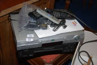 A Matsui VHS player, a Logic DVD, CD and MP3 player and a quantity of remotes.