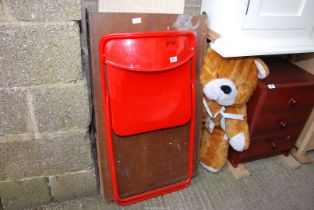 A pasting table, large teddy bear and a metal/plastic fold up chair.