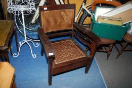 A cane seated armchair.