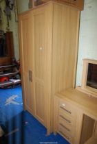 A light Oak finished wardrobe.