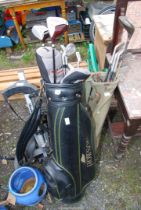 A quantity of golf irons, Palmer and Jemon and golf trolley and bags.