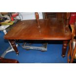 A Victorian Mahogany extending/wind-out Dining Table on castors, 55'' x 41'' x 27 1/2'' high.