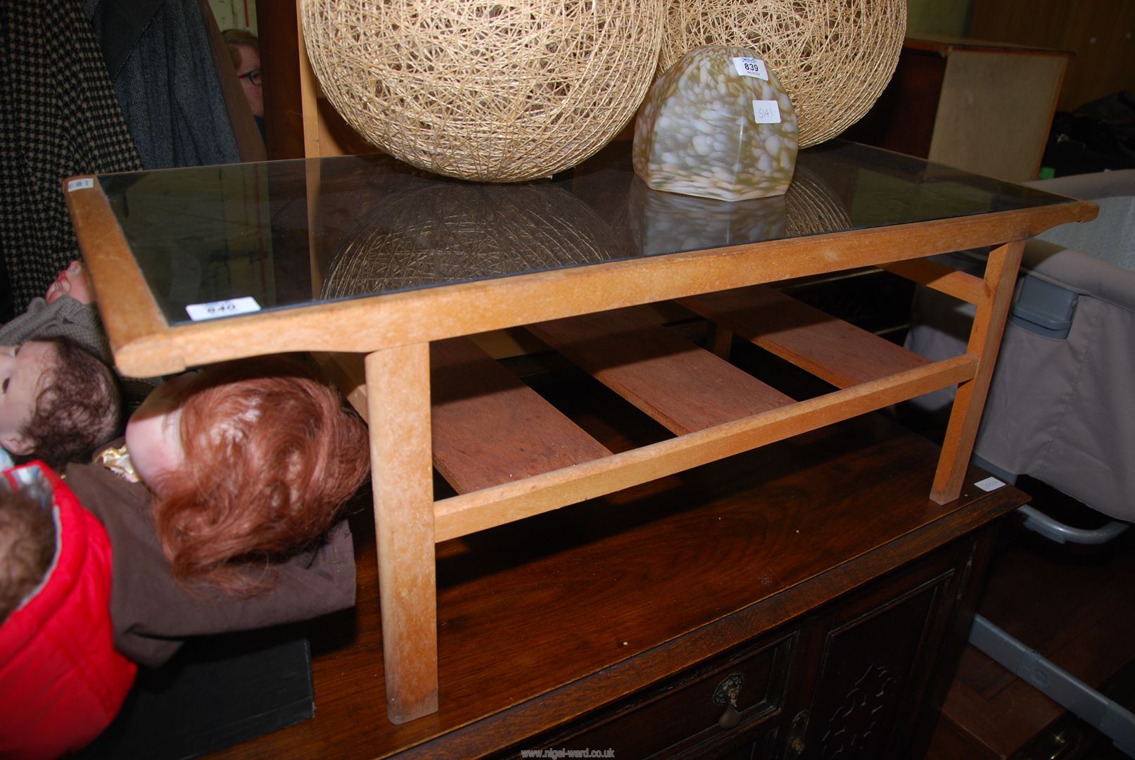 A glass topped Teak coffee table.