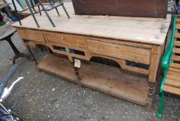 An Oak pot board Dresser base having three drawers and pot shelf, 73" long x 16" deep x 34" high.