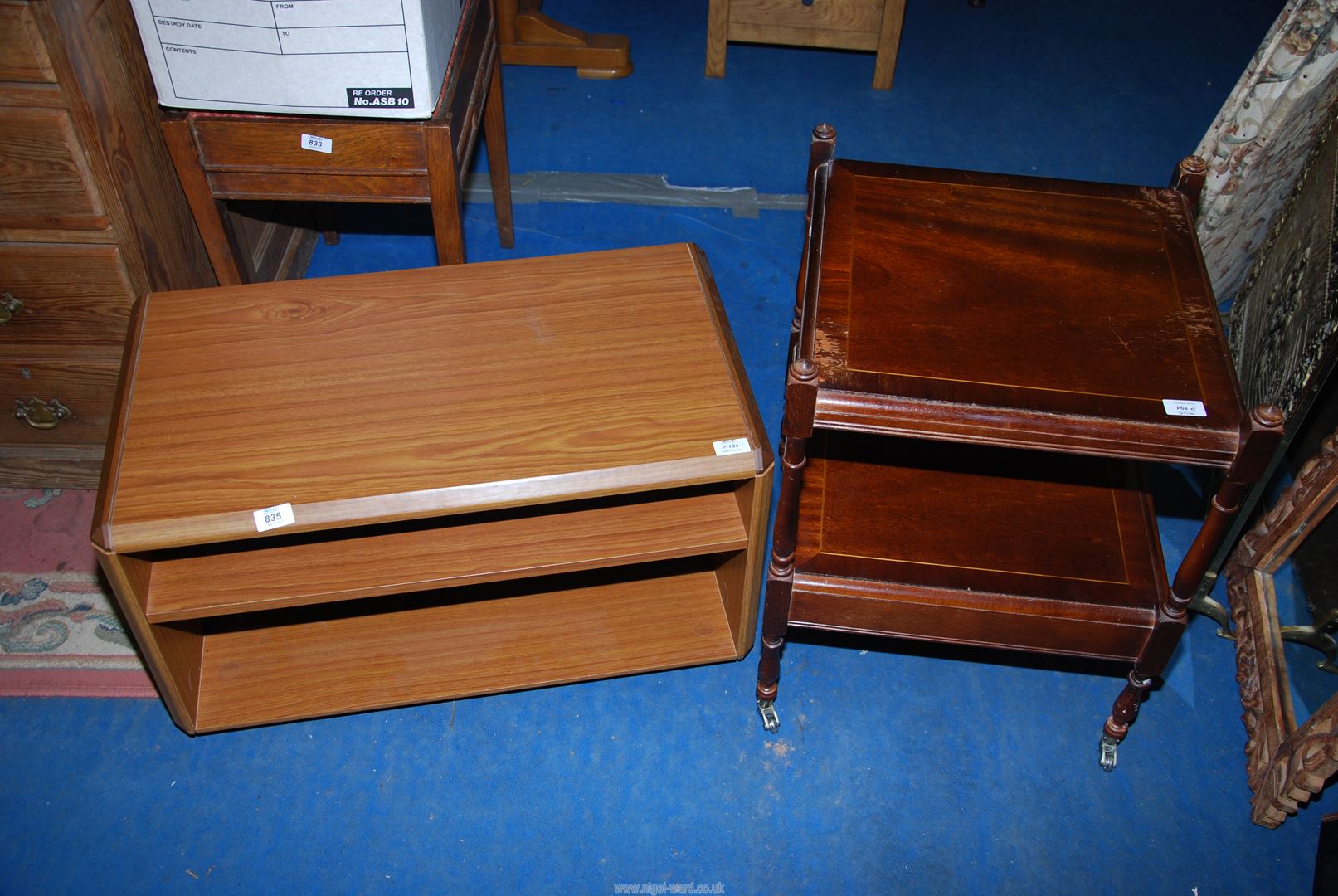 A small Mahogany occasional table on wheels and TV unit.