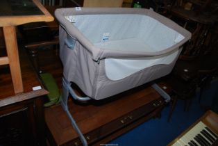 A baby crib on a metal stand.