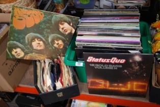A box of LP's and a box 45 rpm records including The Beatles, Status Quo, etc.