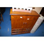 A Yew-wood CD Cabinet, 26'' wide x 29 3/4'' high x 10'' deep.