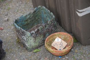 A terracotta and a concrete planter.