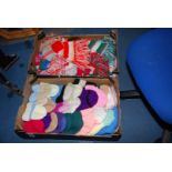 A box of knitted hats and scarves.