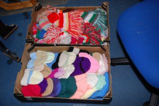 A box of knitted hats and scarves.