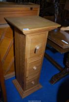 A three drawer upright pine drawer unit 36 1/2" high x 40 1/2" square top.