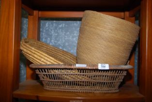 A wicker tray, basket and waste paper bin.